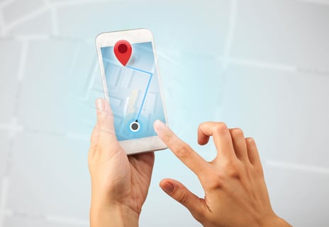 Female fingers touching smartphone with map-1
