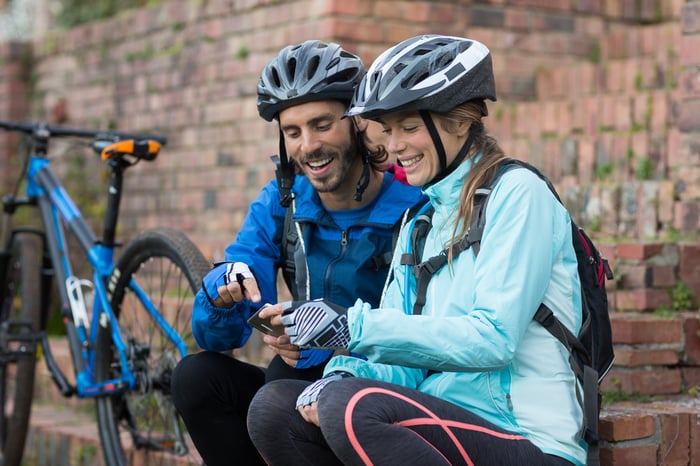 Biker students using mobile phone