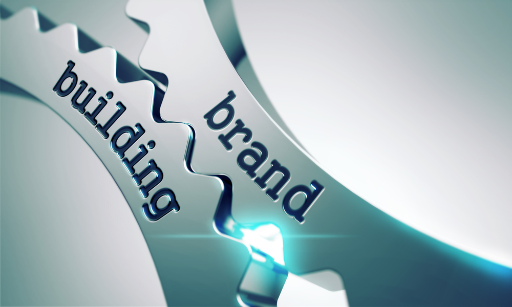 higher education marketing: The words brand and building on interlocking gears.