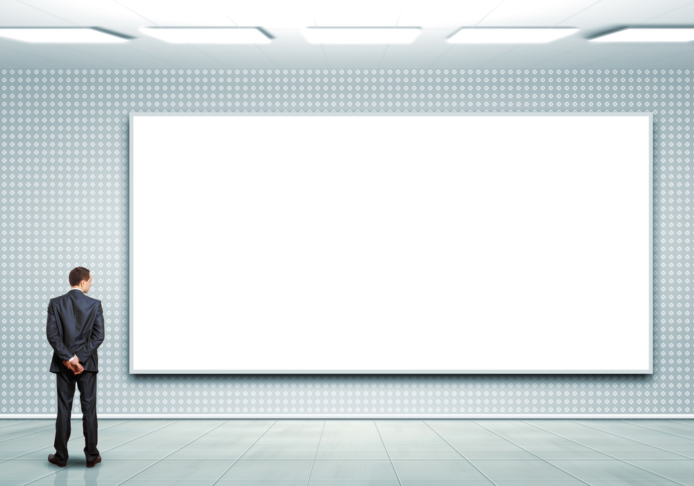 man looking at a blank billboard - high-fidelity OOH is the antidote to digital ad fatigue