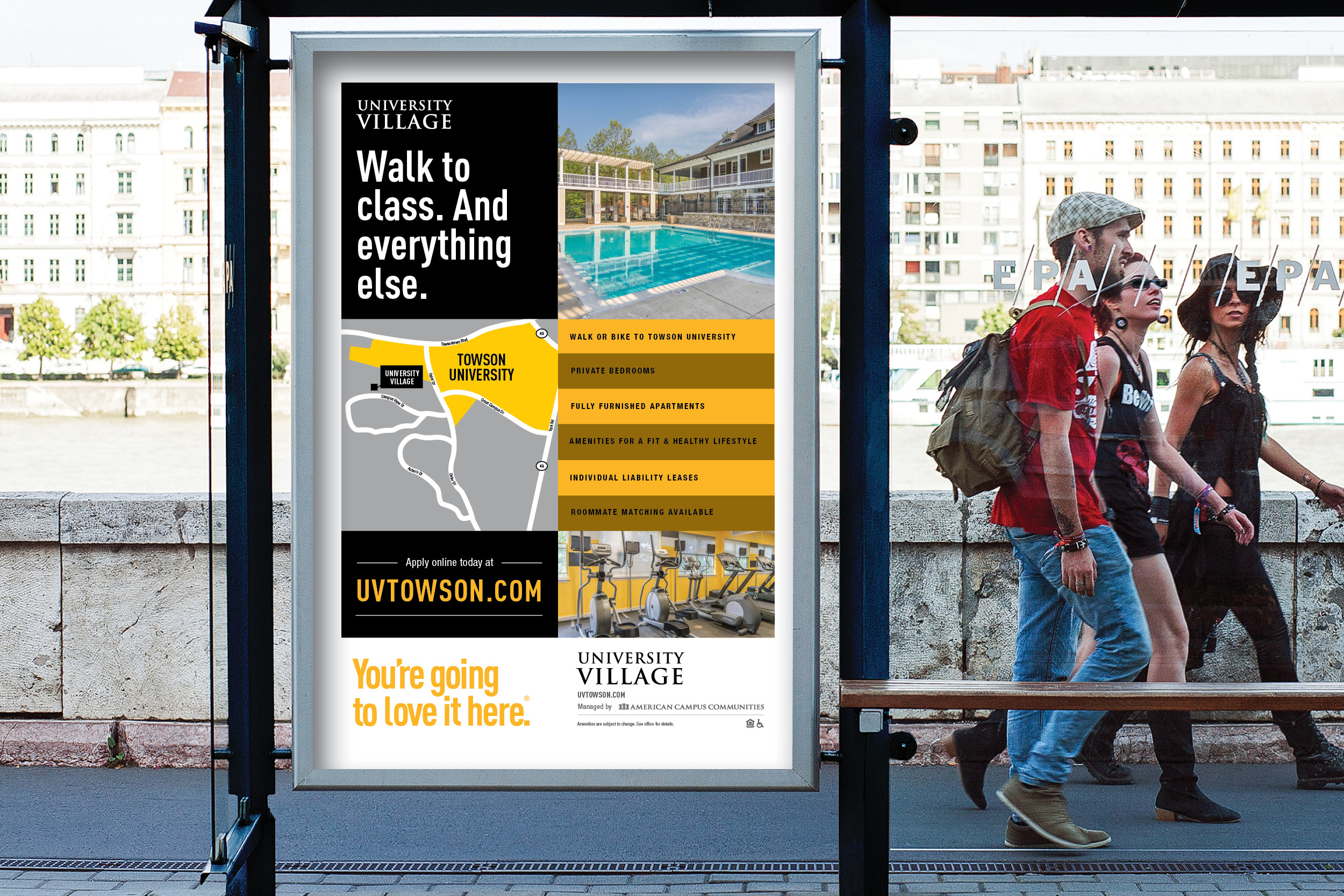 University Village signage on campus bus shelter with students walking by.